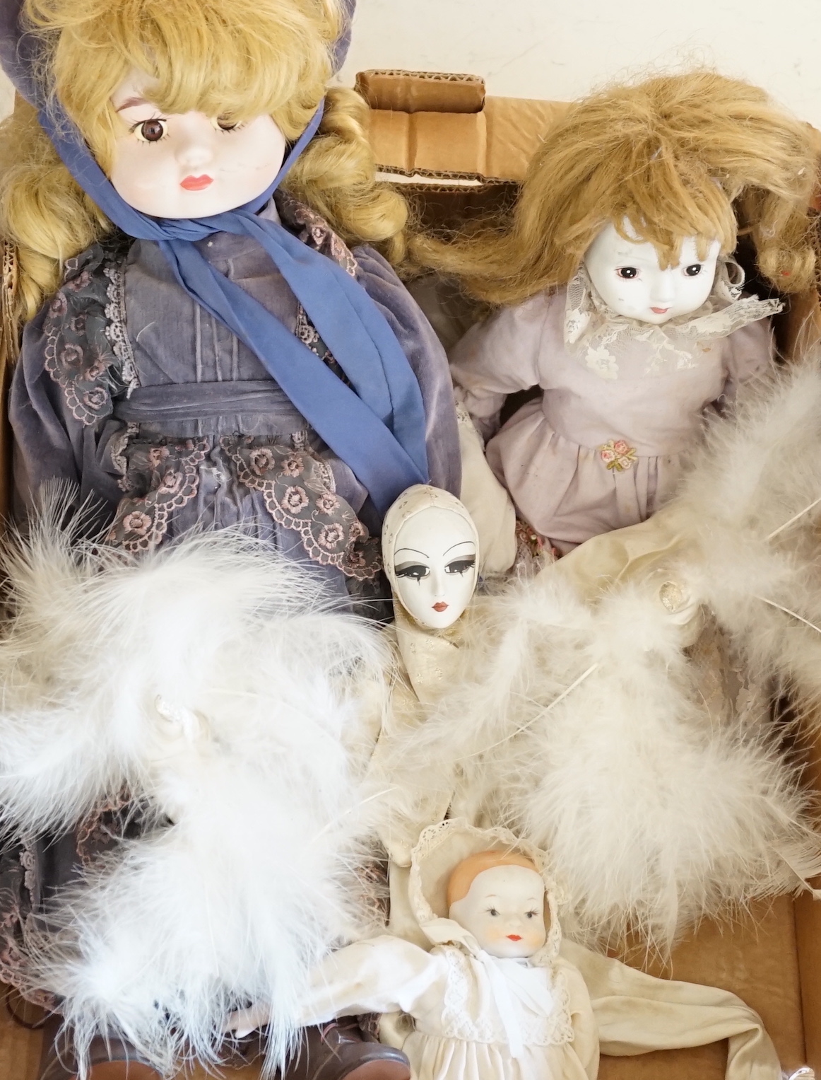 Four modern bisque dolls, largest 56cm